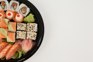 Set of assorted sushi kept in a round black box