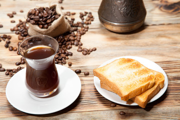 Breakfast, toast and Turkish coffee on a wooden background