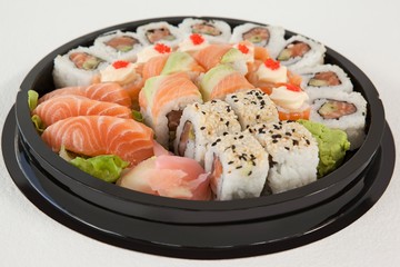Set of assorted sushi kept in a round black box