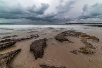 Dramatic storm seascape with moody sky and powerful surf