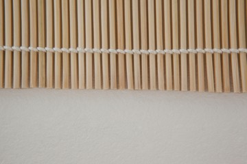Straw sushi mat against white background