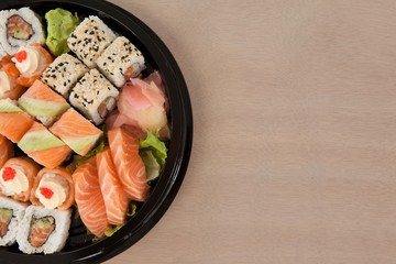 Set of assorted sushi kept in a black round box