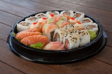 Nigiri sushi served with soy sauce in white plate