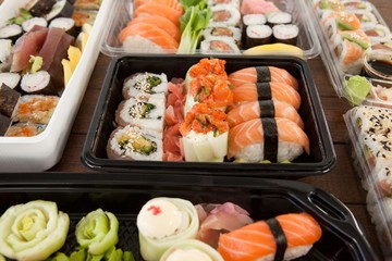 Assorted sushi set served in plastic boxes