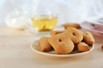 Cookie alphabet and tea on table