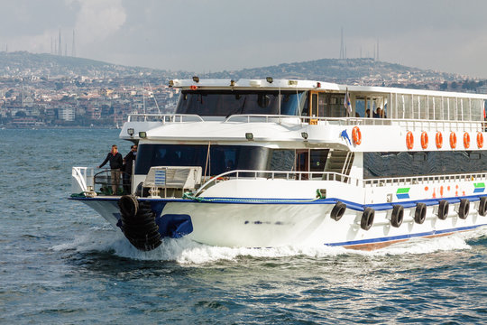 Sunny view of Bosphorus with excursion boat, Istanbul, Turkey.