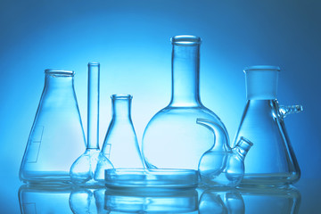 Test beakers and flasks on color background
