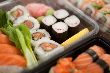 Assorted sushi set served in plastic boxes