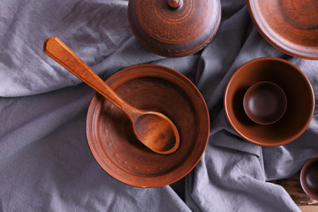 Set of dishes with tablecloth on wooden table