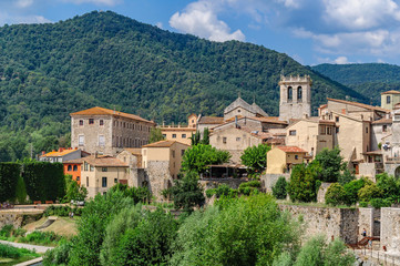 Fototapeta premium Cityscape of the historic Catalan city of Besalu, mountains in t