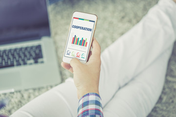 Business Charts and Graphs on screen with COOPERATION title