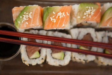 Uramaki sushi served with chopsticks and soy sauce