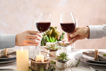 People toasting with glasses of red wine, closeup
