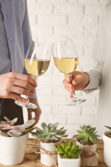 People toasting with glasses of white wine, closeup