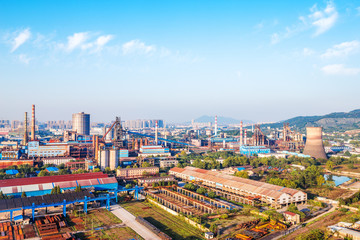 Obraz premium constructions of steel factory in blue sky