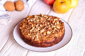 homemade apple pie with nuts on a plate, horizontal, top view