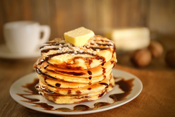 Delicious pancakes with chocolate syrup on plate