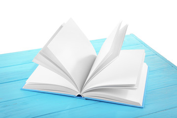 Opened book on blue wooden table