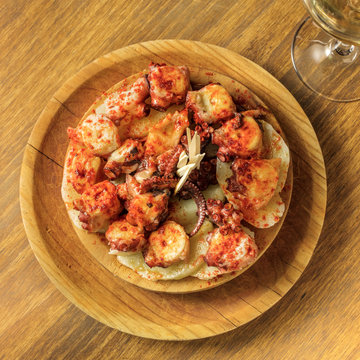 Photo of octopus with fried potatoes, typical Spanish dish