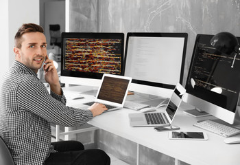 Handsome young programmer working in office