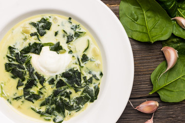 Top View Spinach Soup on Wooden Background with Garlic