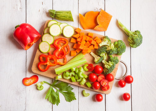 Fototapeta Various cut vegetables on cutting board