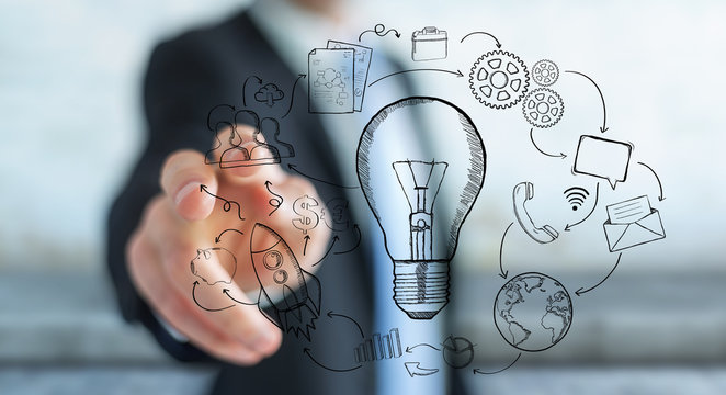 Businessman touching hand drawn lightbulb and multimedia icons