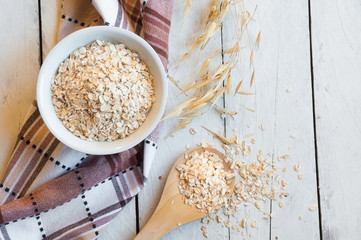 Oat flakes on wooden table