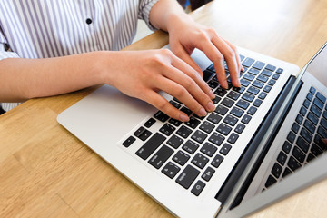Fototapeta na wymiar Woman office worker is typing keyboard of laptop, business or le