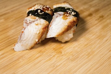 Fresh Japanese sushi and rolls on wooden table. Macro shot.