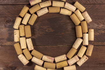 Wine corks circle on wooden texture with copyspace