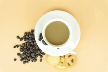 Coffee cup and coffee beans on Orange background.