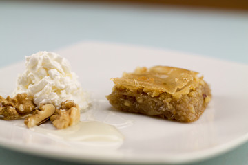 Baklava served with greek yogurt walnuts and honey