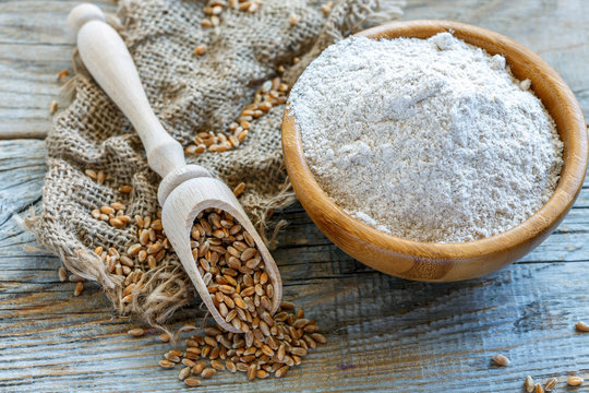 Wholegrain wheat flour in a wooden bowl.