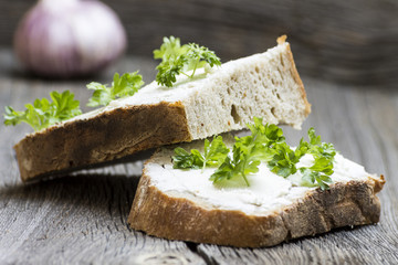 Fresh Bread Slices with Garlic on Wooden Background