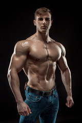 Obraz na płótnie Canvas Young bodybuilder man on black background