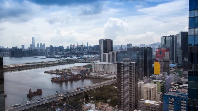 4k Timelapse Top View of Hong Kong Cityscape day whit clouds, skyline of the city near Kowloon Bay with ships and cars in freeway front the Harbour -Dan