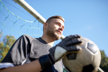 goalkeeper with ball at football goal on field