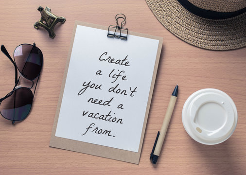 Inspirational motivating quote on notebook and travel objects