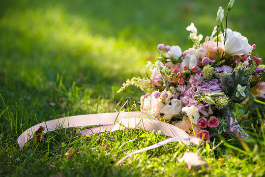 wedding fresh bouquet lays on the grass