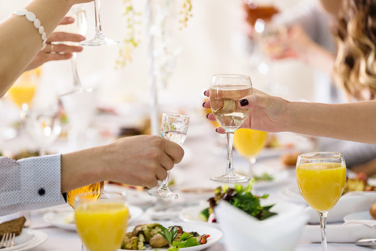 Group Of People In Banquet Hall Toasting. Toasting Glasses