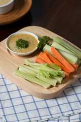 Vegetable sticks. Fresh celery and carrot, cucumber with sauce..