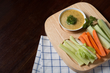 Vegetable sticks. Fresh celery and carrot, cucumber with sauce..