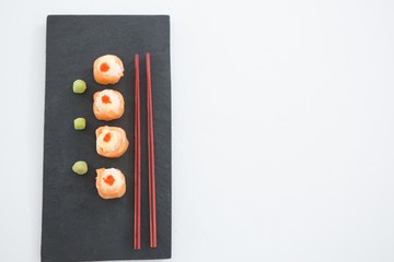 Sushi served on tray with chopsticks
