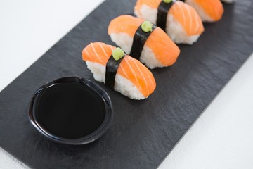 Close-up of nigiri sushi served on black stone slate