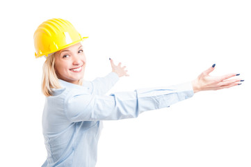 Lady engineer wearing helmet posing with arms open