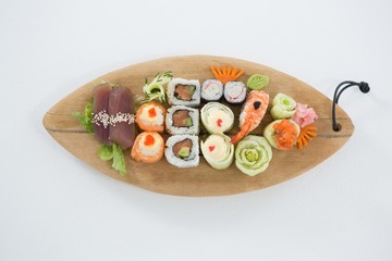 Set of assorted sushi served on wooden tray