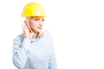 Lady engineer wearing helmet making not hearing gesture