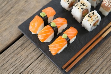 Set of assorted sushi served on black stone slate
