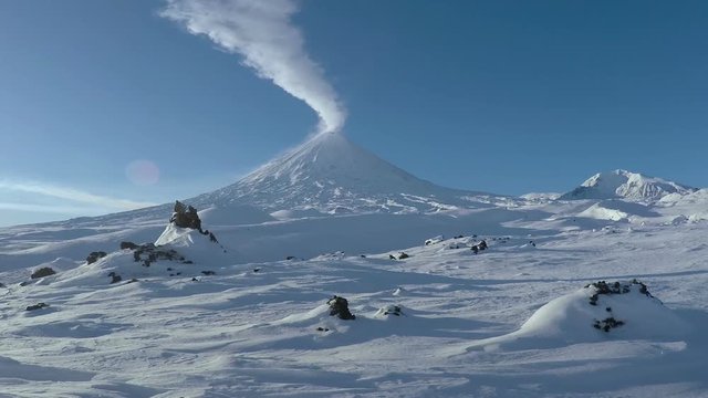 Winter landscape of Kamchatka Peninsula: eruption active Klyuchevskoy Volcano (Klyuchevskaya Sopka), explosive-effusive eruptions, gas-steam activity of volcano. Russian Far East.